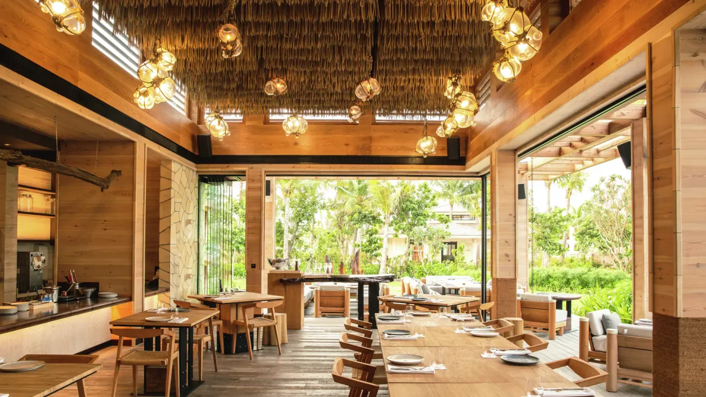 Interior of The Ledge by Dave Pynt in the Maldives, with wooden tables and elegant decor