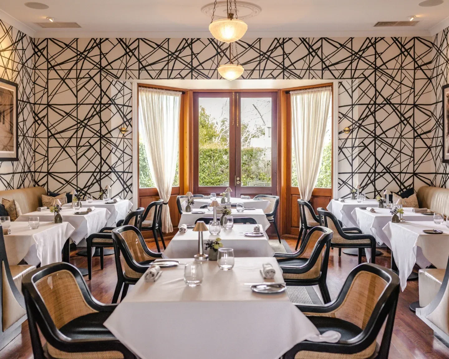 Elegant dining room at The Long Apron restaurant on the Sunshine Coast with geometric wallpaper.