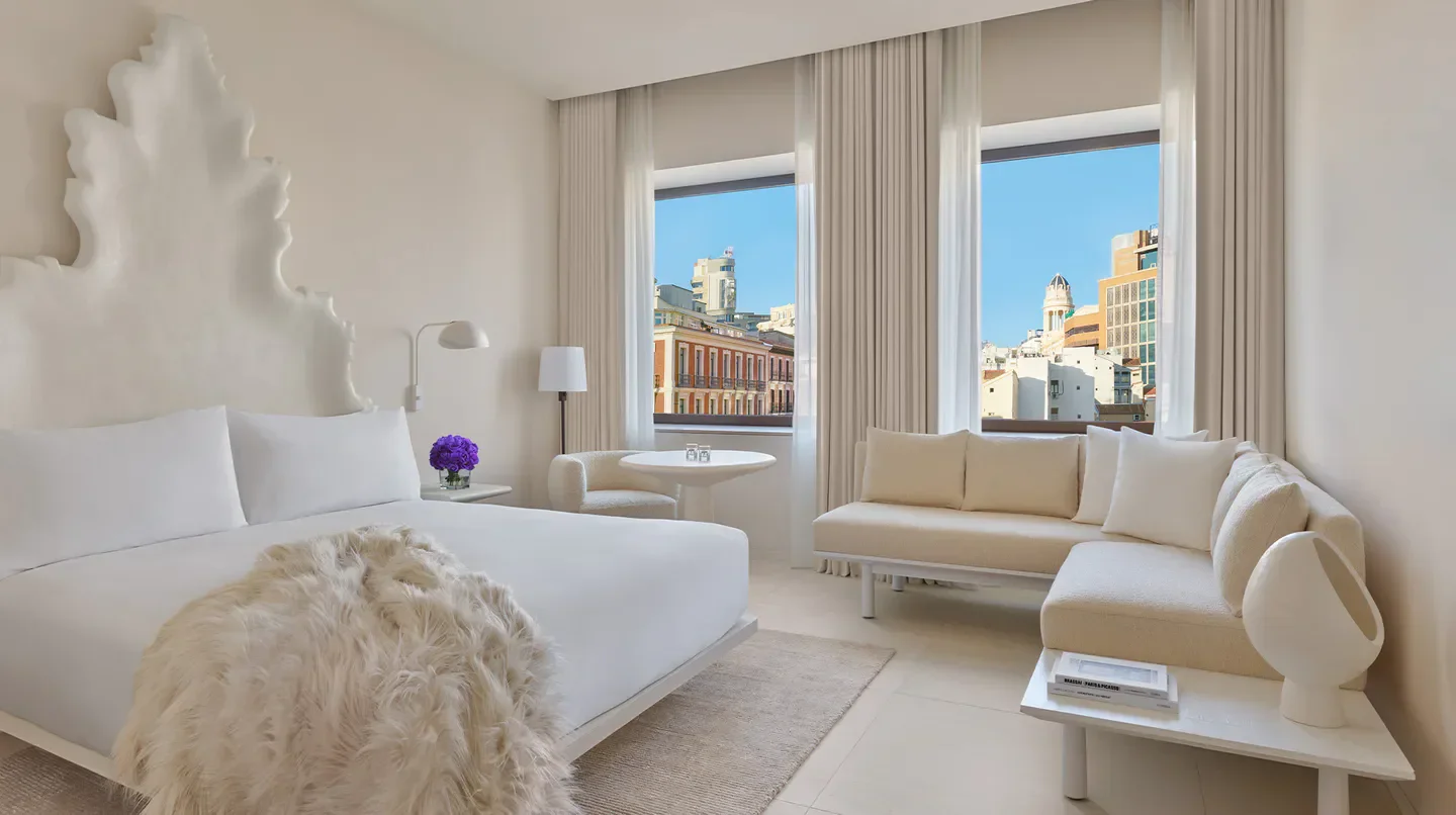Bright, modern guest room at The Madrid EDITION hotel, showcasing city views in Madrid.
