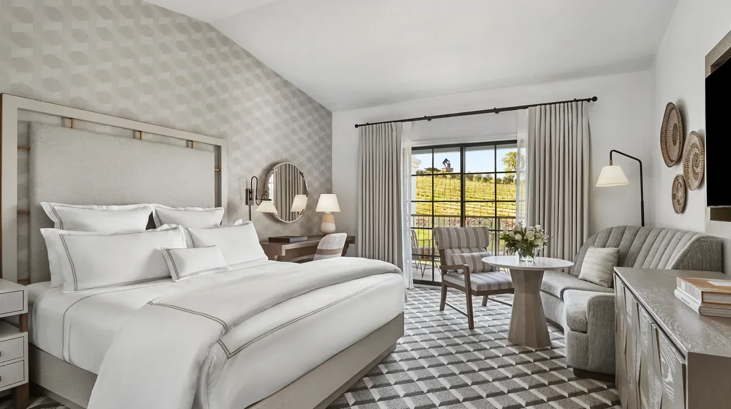 Cozy bedroom at The Meritage Resort and Spa in Napa, with vineyard views.