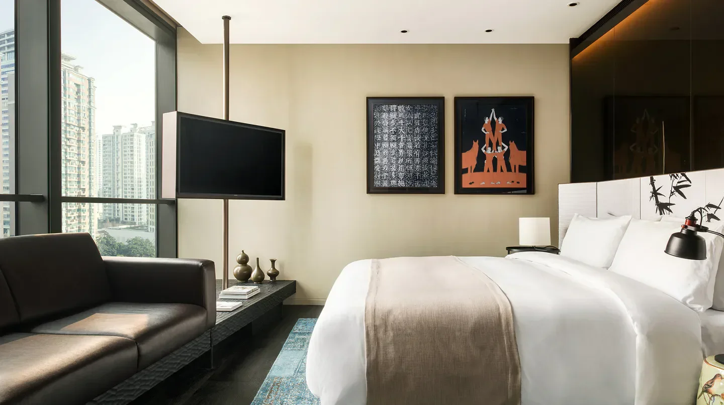 Elegant bedroom at The Middle House Shanghai, featuring city views and stylish decor.
