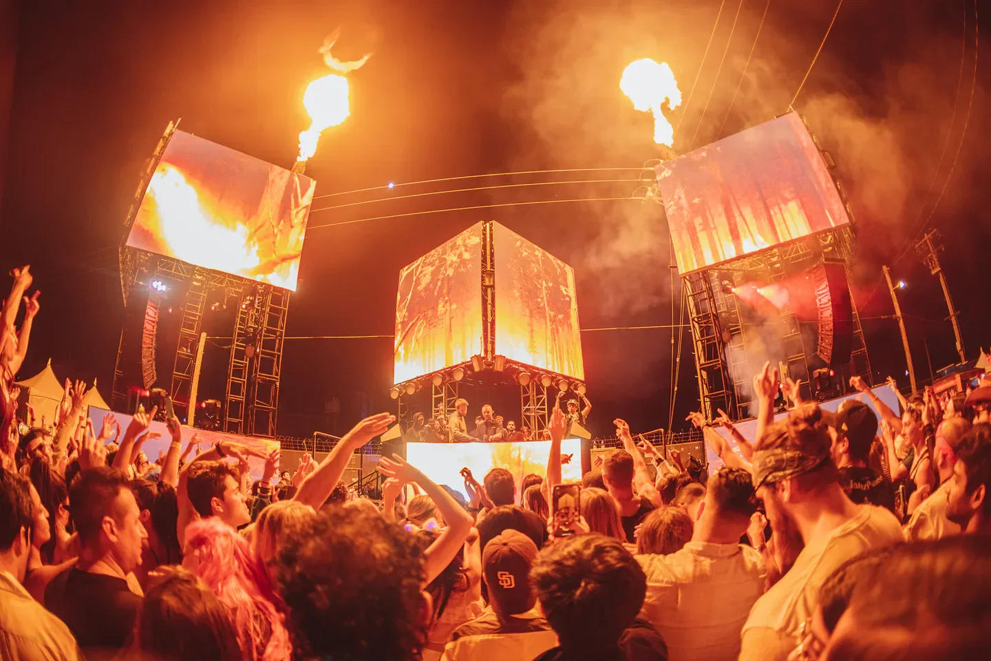 Energetic crowd at The Midway in San Francisco, with stage visuals and fire effects.
