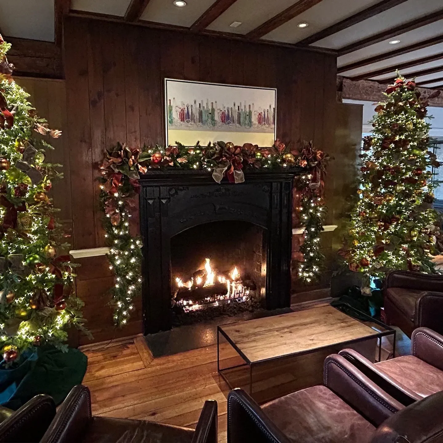 Cozy holiday scene inside The Mill Room restaurant in Charlottesville with fireplace.