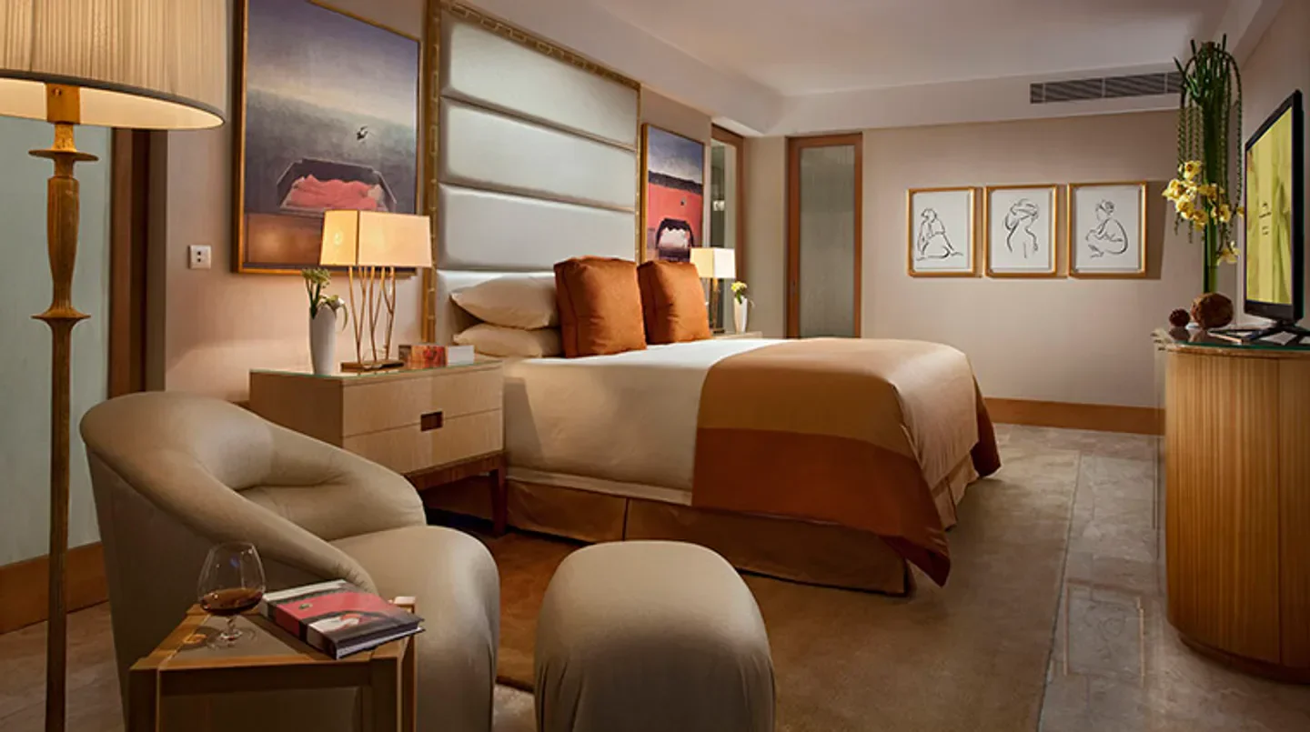 Cozy bedroom at The Mulia - Nusa Dua, Bali, featuring elegant decor and artwork.