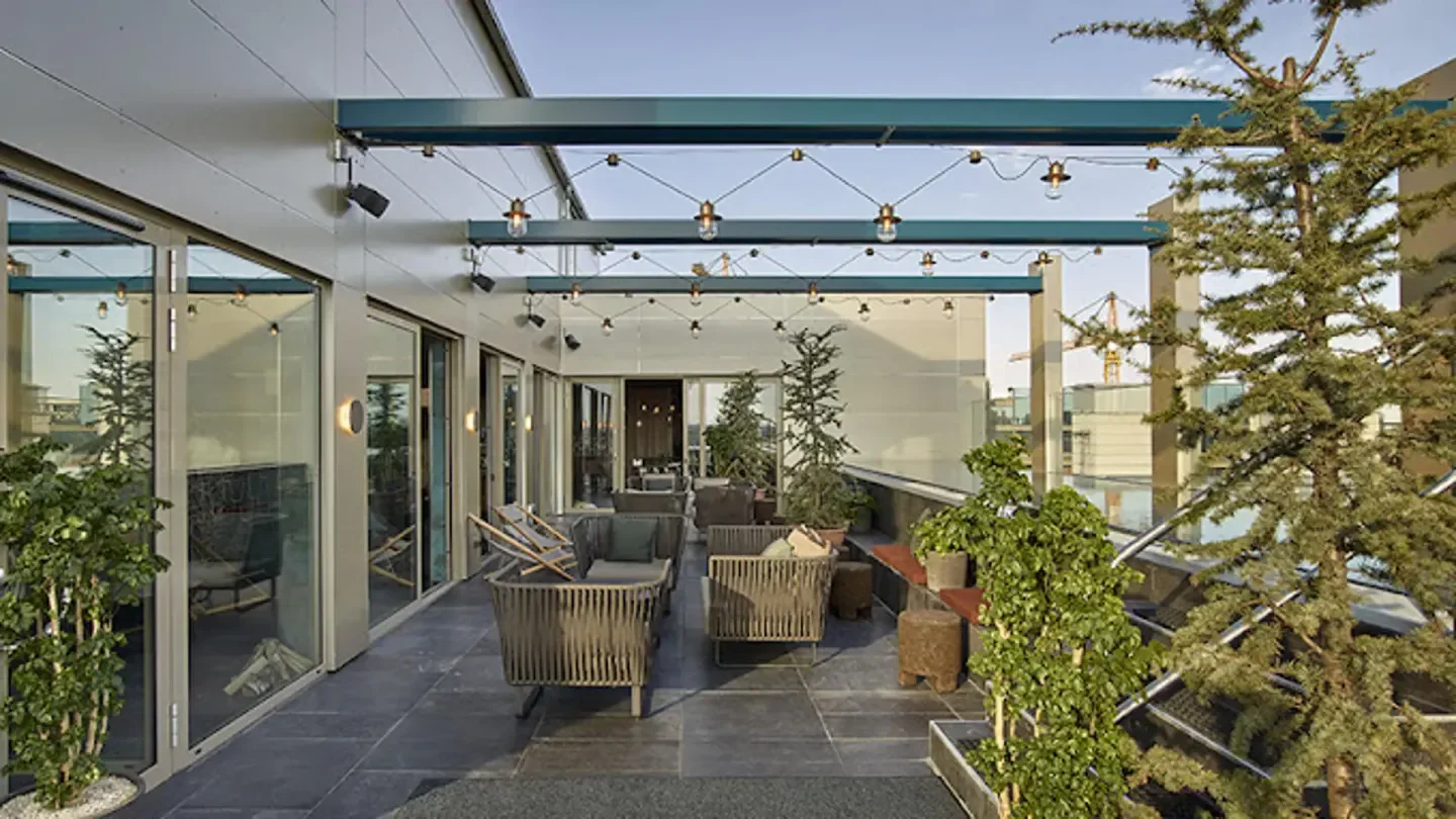 Rooftop terrace at The Nest in Stockholm, featuring stylish seating and string lights.