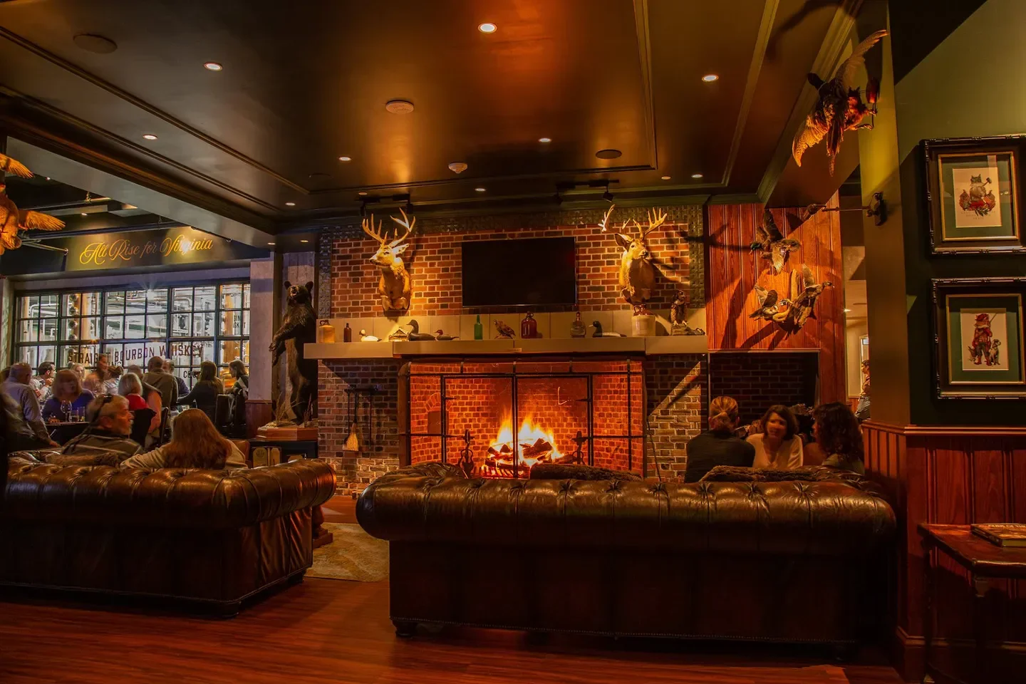 Cozy interior of The OAK room & bar in Virginia Beach, featuring a fireplace.