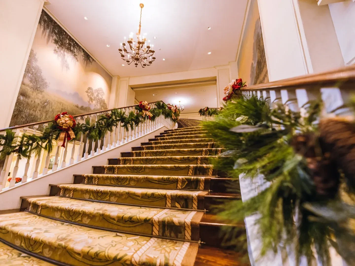 Elegant staircase at The Ocean Room in Charleston, decorated for the holidays.