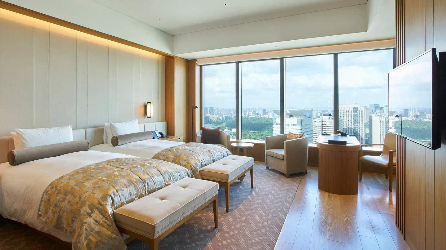 Spacious hotel room with city views at The Okura Tokyo, offering a relaxing stay in Tokyo.