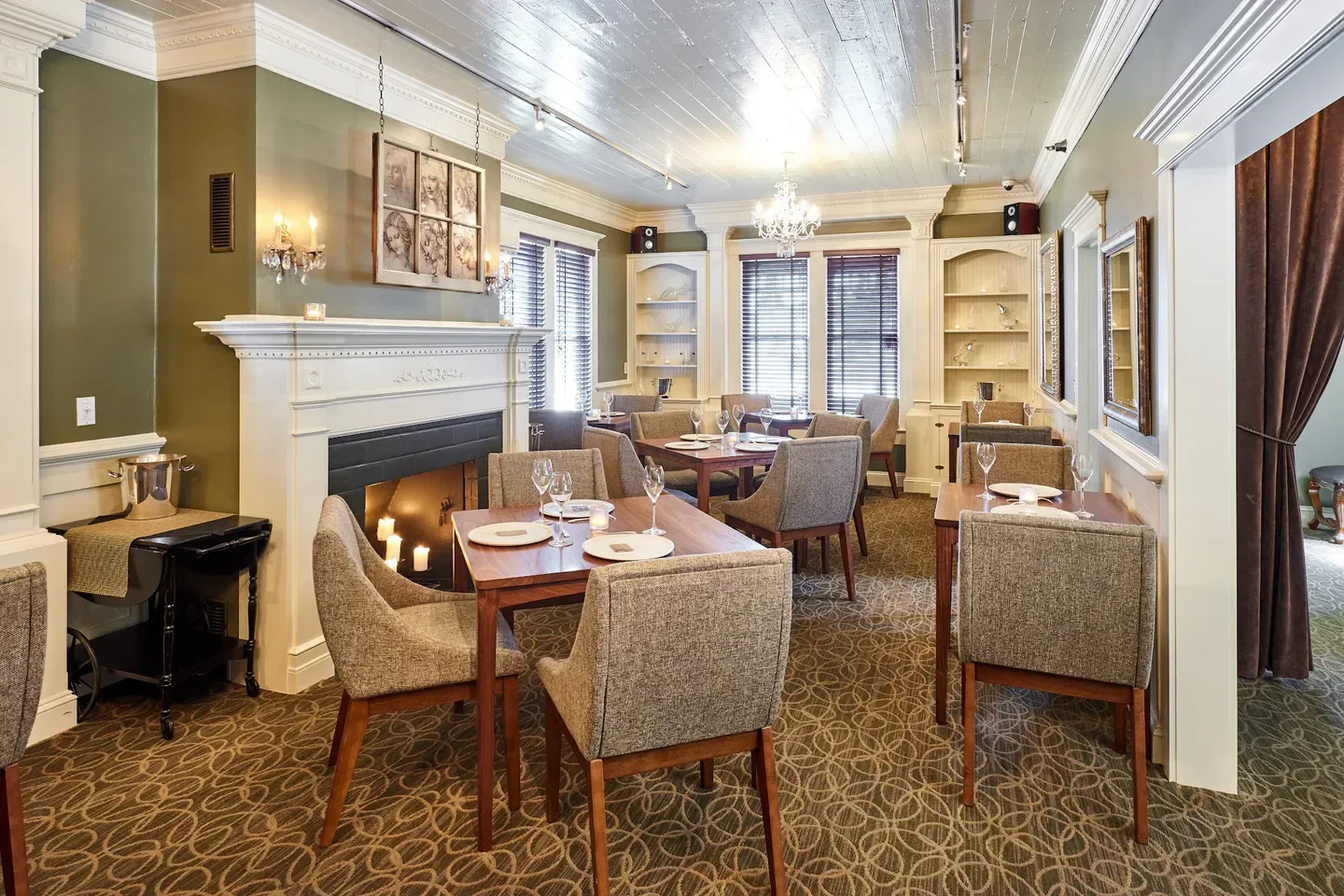Cozy dining area at The Painted Lady Restaurant in the Willamette Valley with fireplace and candles.