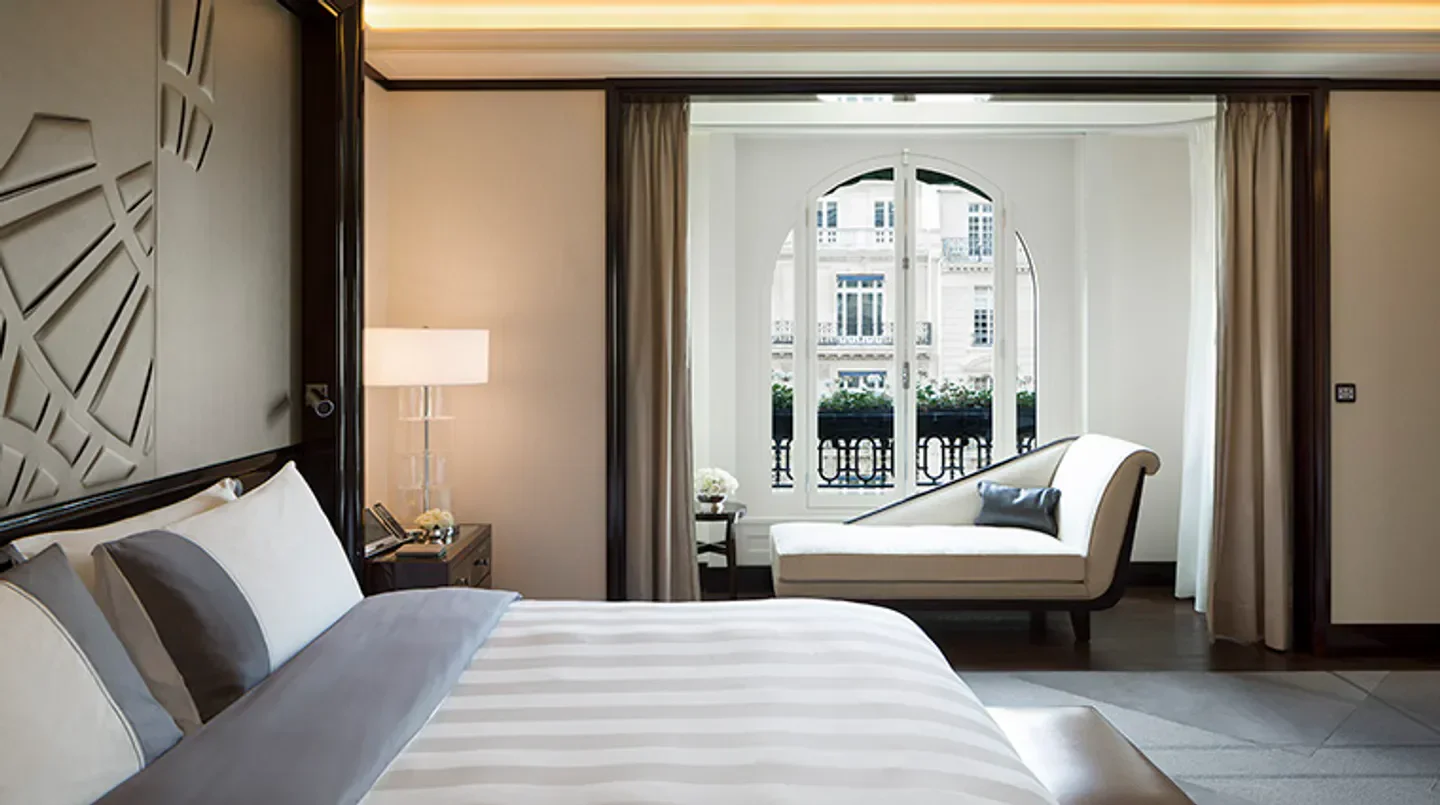 Elegant bedroom at The Peninsula Paris, offering stunning views of Paris.