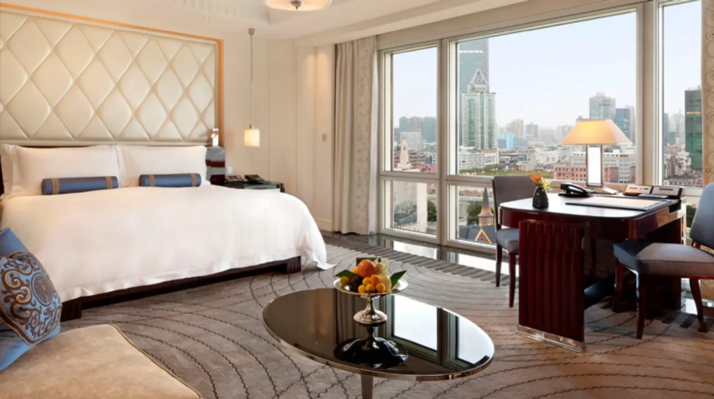 Luxury room at The Peninsula Shanghai with city views of Shanghai.