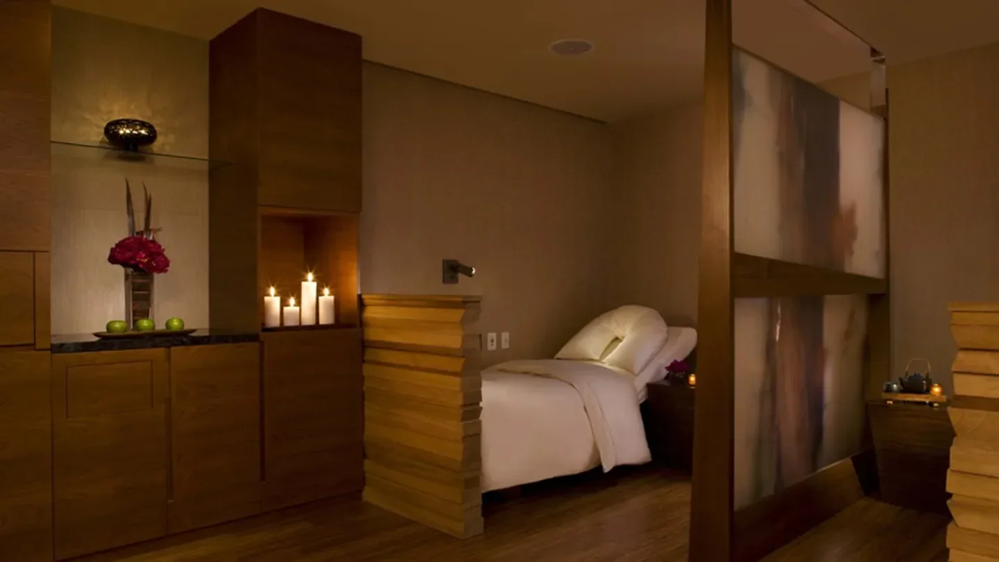 Cozy spa treatment room at The Peninsula Spa New York in New York City with candles.