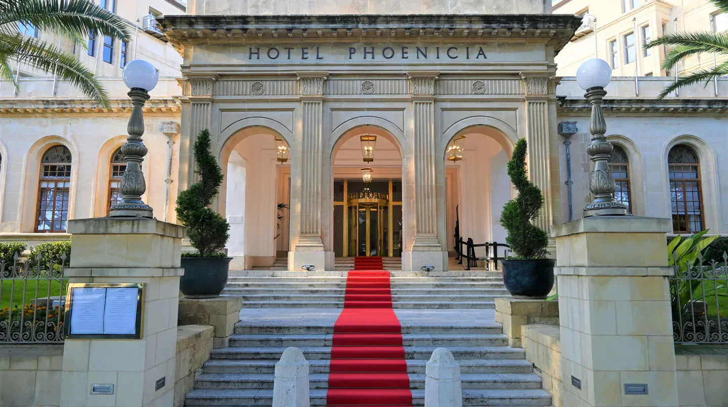 Entrance of The Phoenicia Malta hotel with red carpet, Malta
