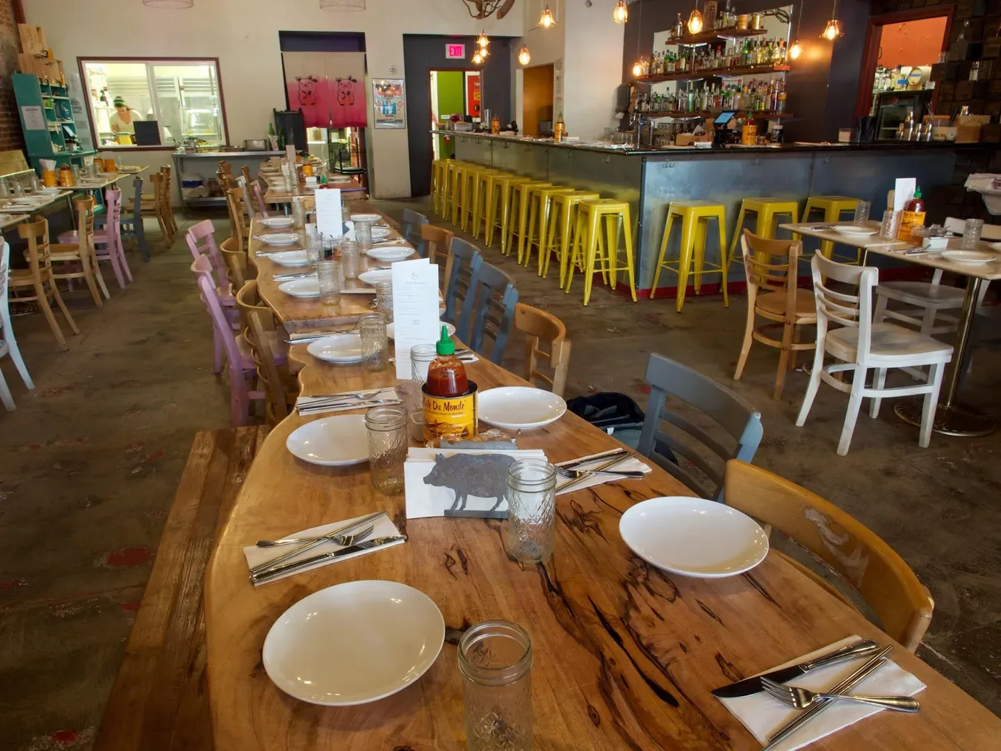 Interior of The Pig and The Lady in Honolulu, featuring long wooden tables and bar.
