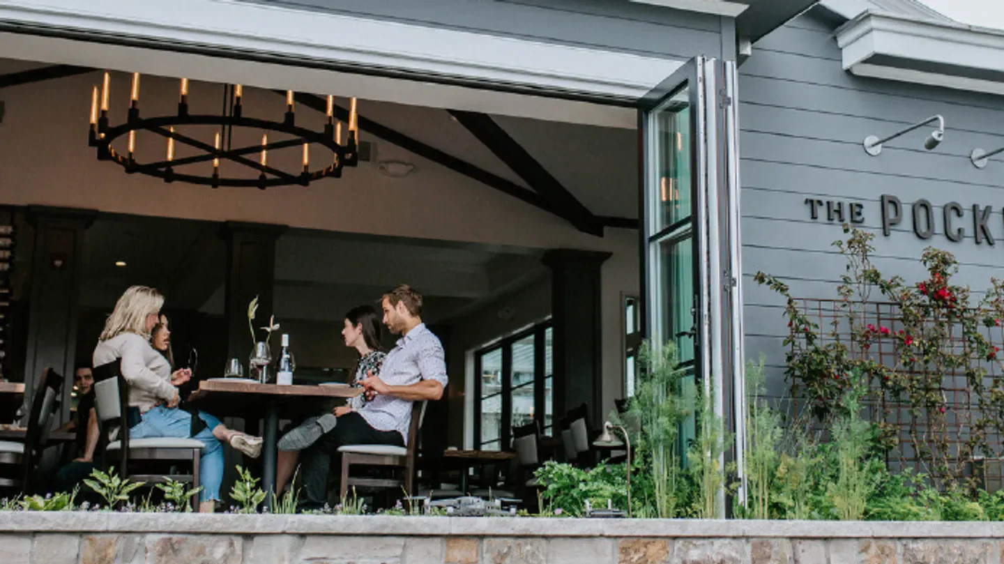 Dining scene at The Pocket restaurant in Carmel, with friends enjoying a meal together.
