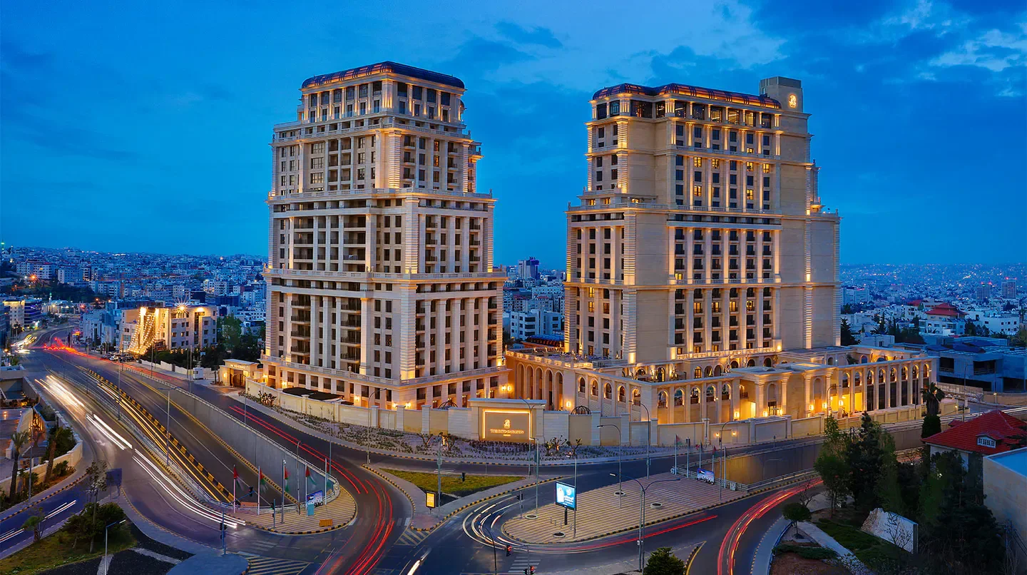 The Ritz-Carlton, Amman hotel at dusk, illuminated in the city of Amman.