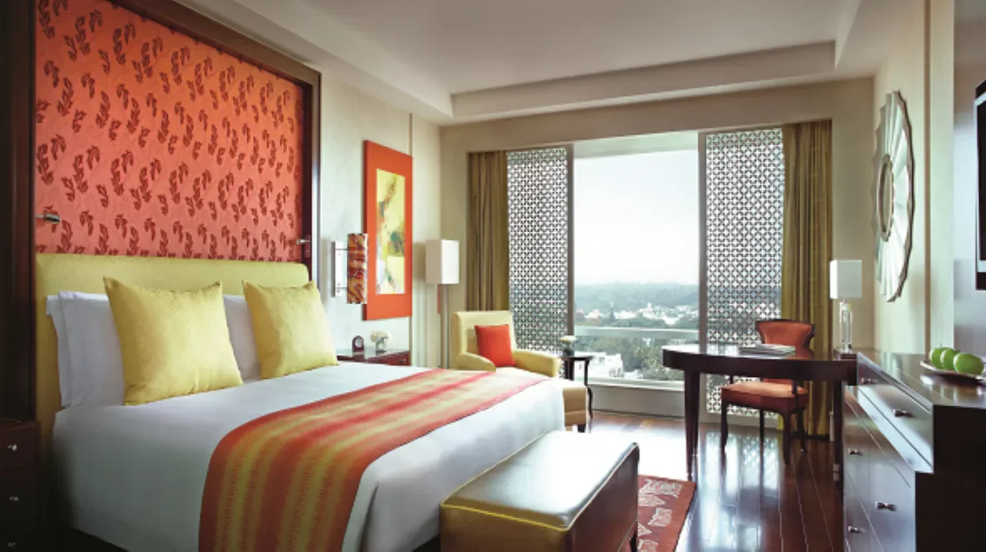 Luxury bedroom at The Ritz-Carlton, Bangalore, showcasing elegant design and city views in Bengaluru.