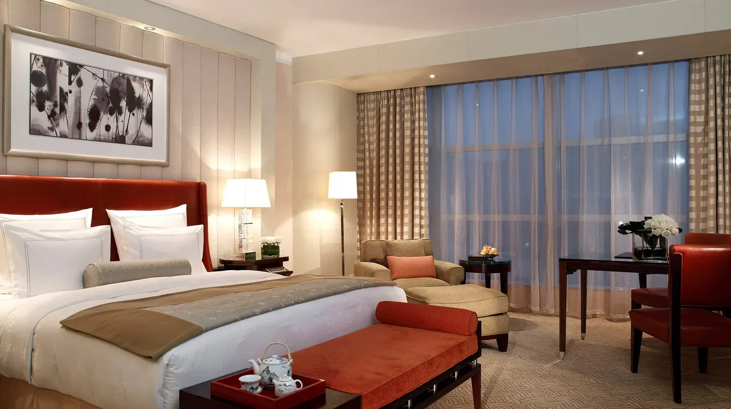 Luxury bedroom at The Ritz-Carlton Beijing, Financial Street, featuring elegant decor and style.
