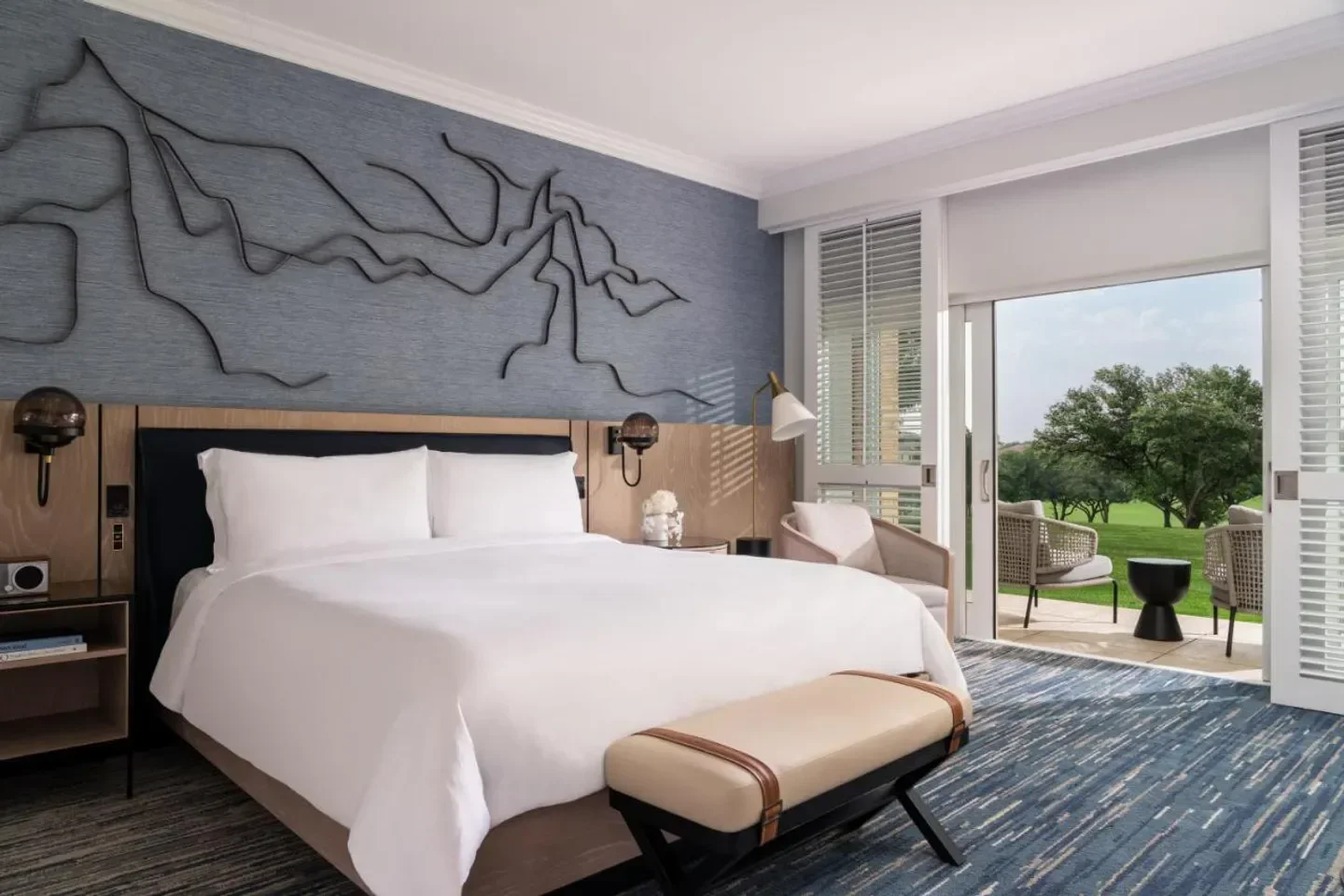 Luxury bedroom at The Ritz-Carlton Dallas, Las Colinas with a view of Dallas' golf course.