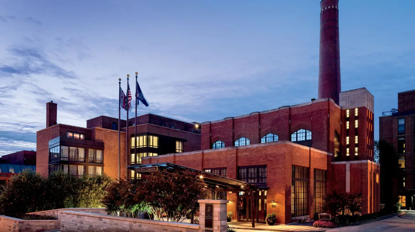 Exterior of The Ritz-Carlton Georgetown, Washington, D.C., at dusk, red brick facade.