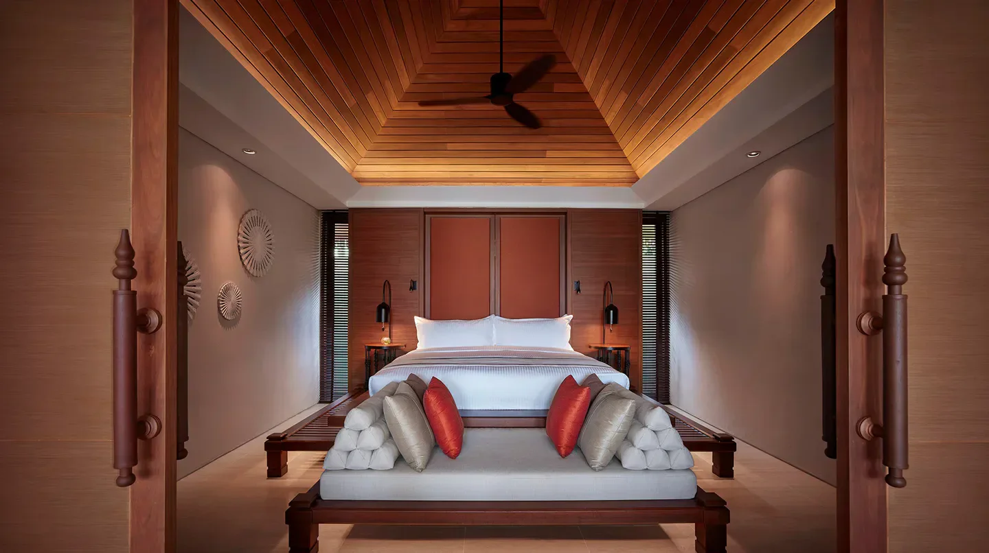 Bedroom interior at The Ritz-Carlton, Koh Samui, featuring a luxurious bed and decor.