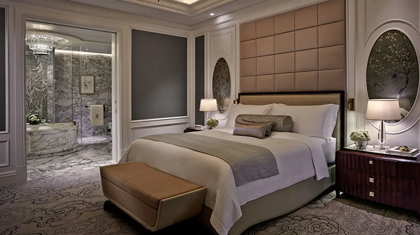Luxury bedroom at The Ritz-Carlton, Macau hotel. Stylish design with a marble bathroom in Macau.