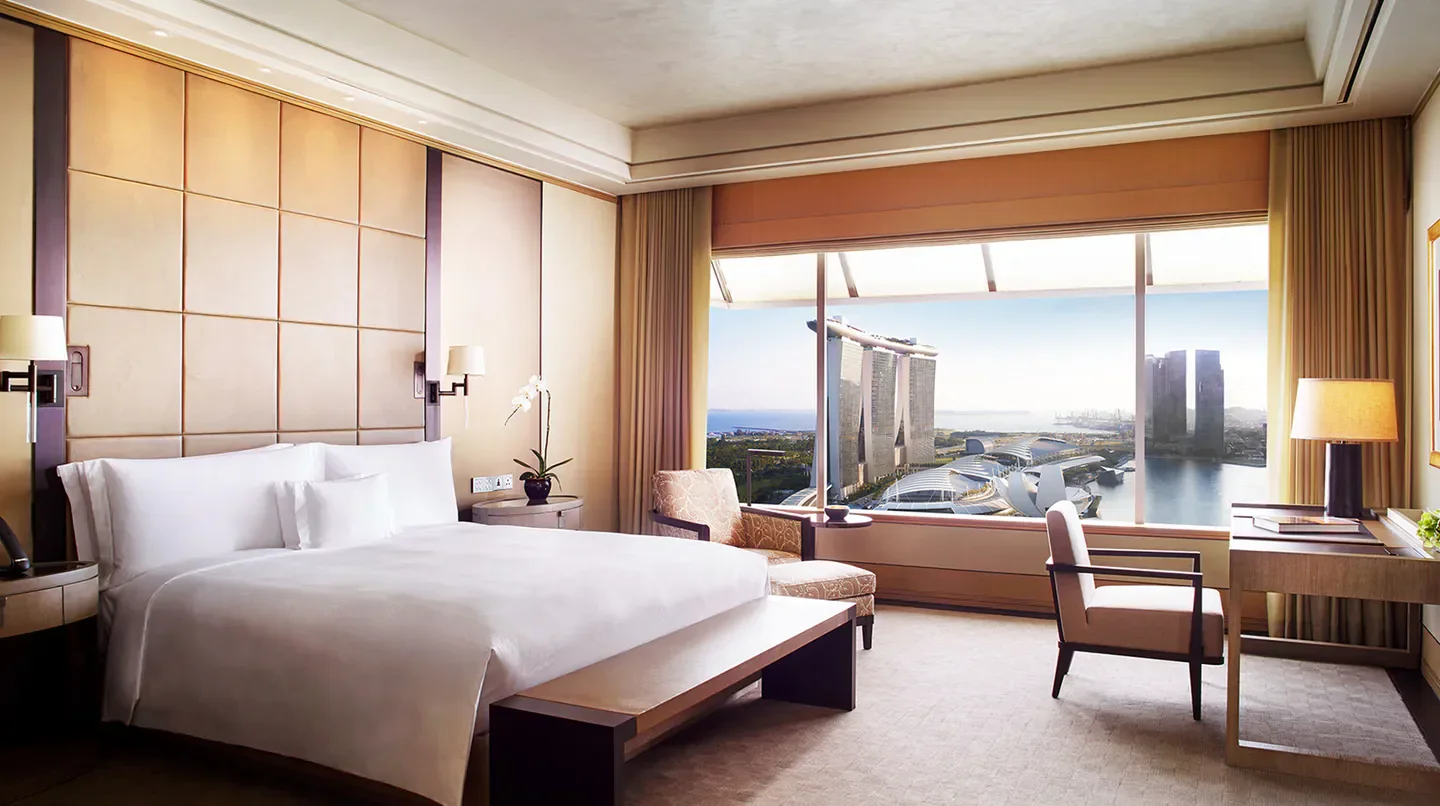 Luxury room with city view at The Ritz-Carlton, Millenia Singapore, overlooking Singapore skyline.