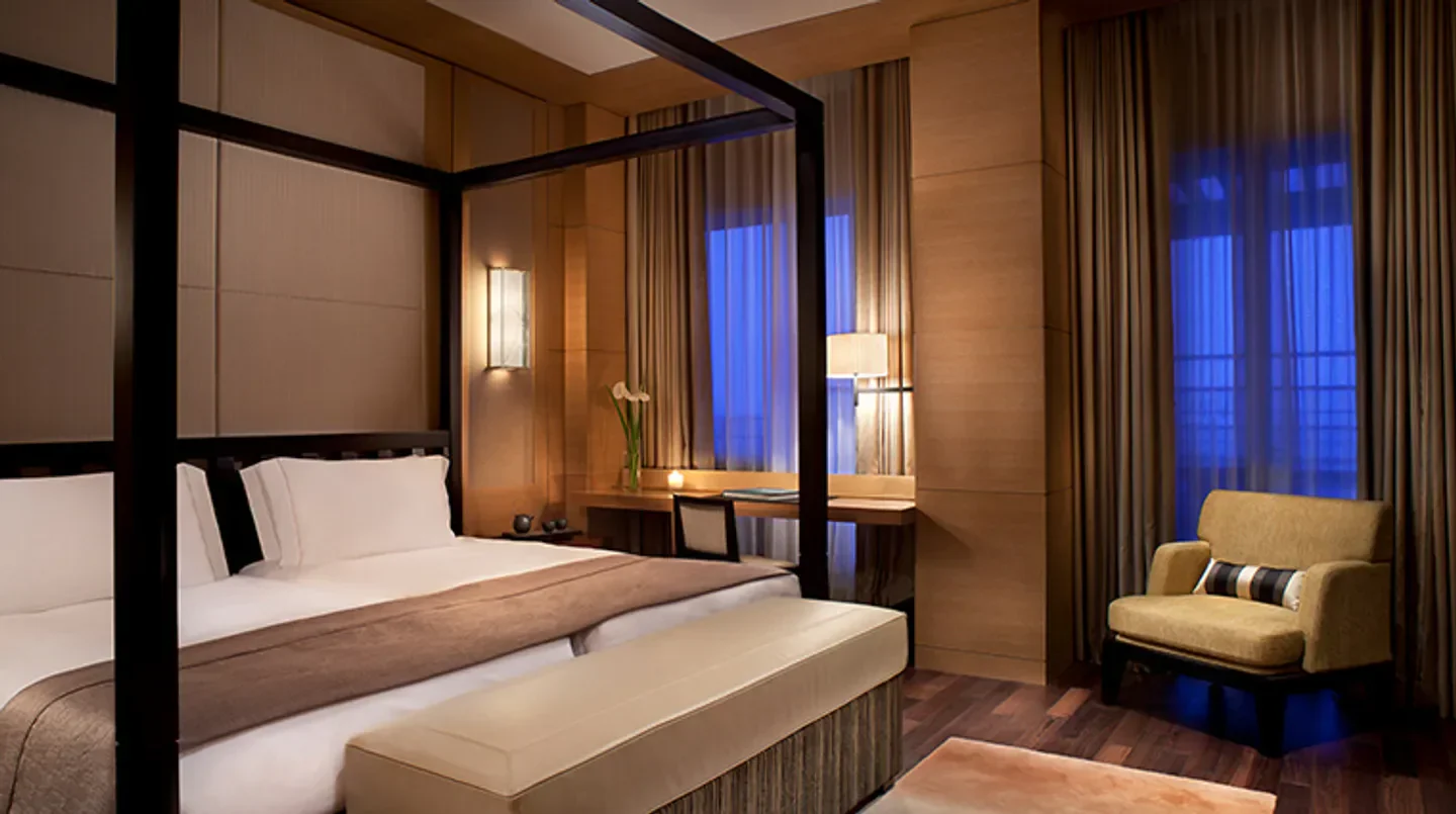 Cozy bedroom at The Ritz-Carlton, Okinawa, featuring a four-poster bed in Okinawa.