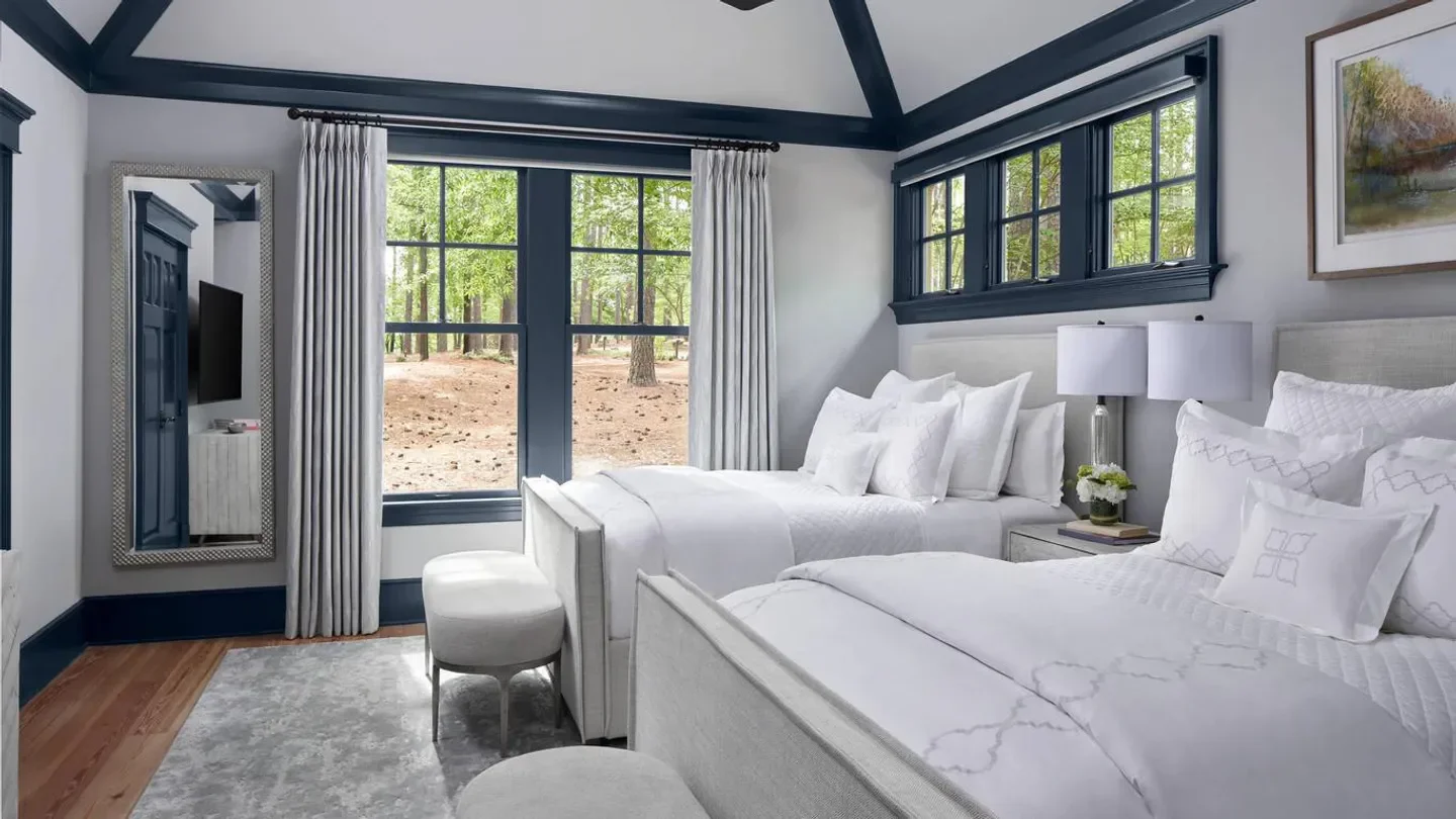 Cozy bedroom at The Ritz-Carlton Reynolds, Lake Oconee near Atlanta with forest views.