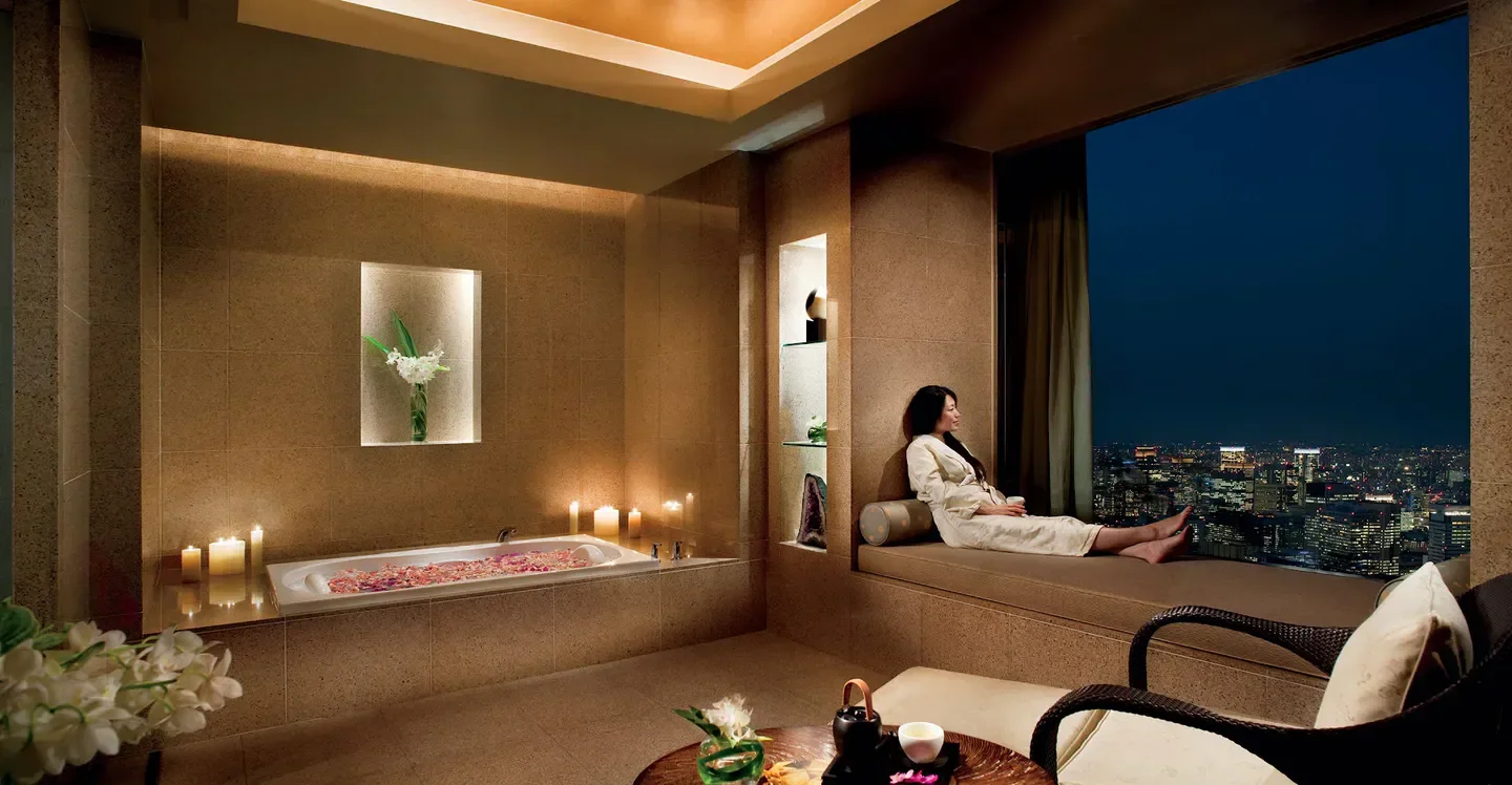 Relaxing spa experience at The Ritz-Carlton, Tokyo Spa & Fitness, overlooking Tokyo city lights.