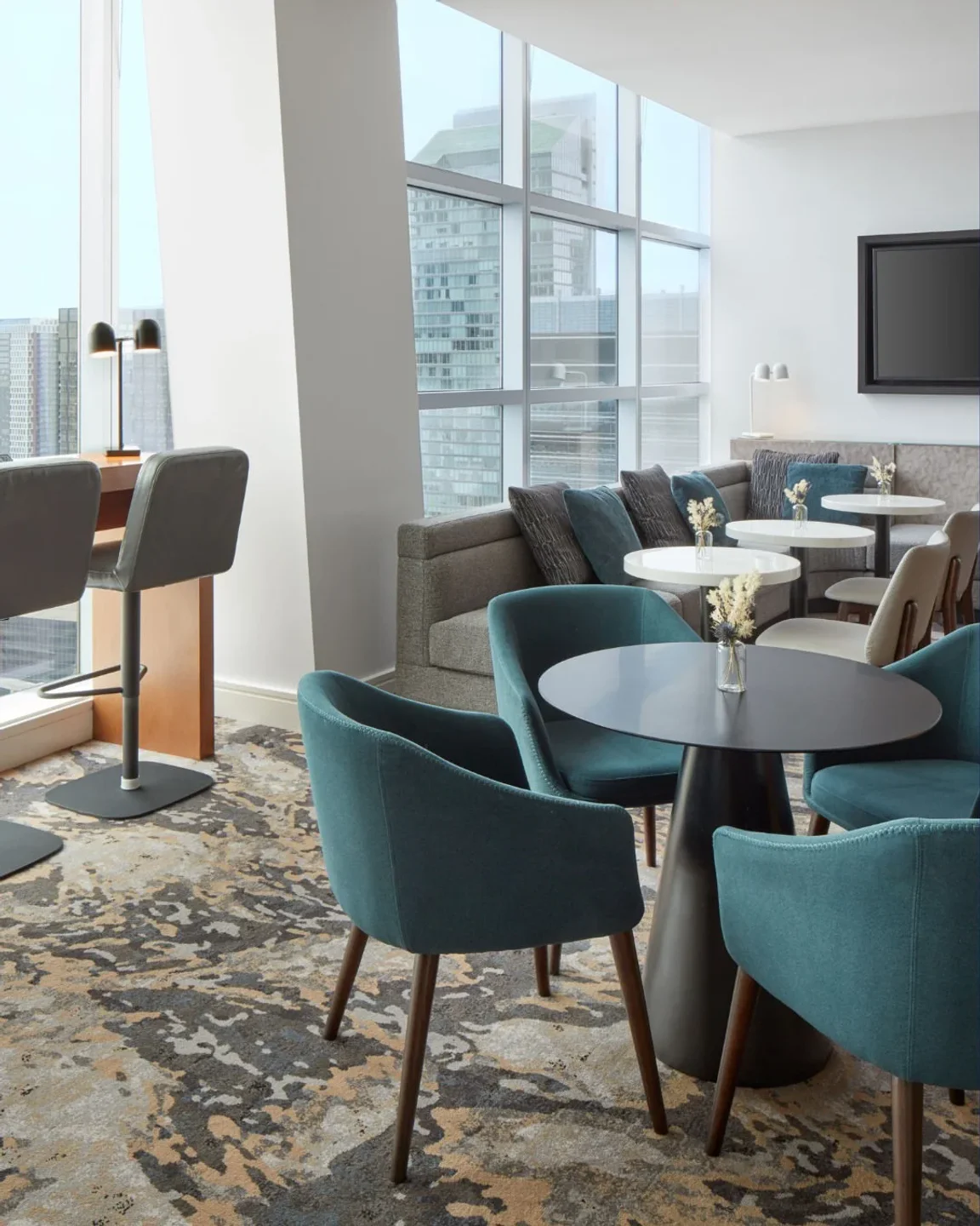 The Roof at SOCO Toronto offers chic teal seating and modern tables with city views.