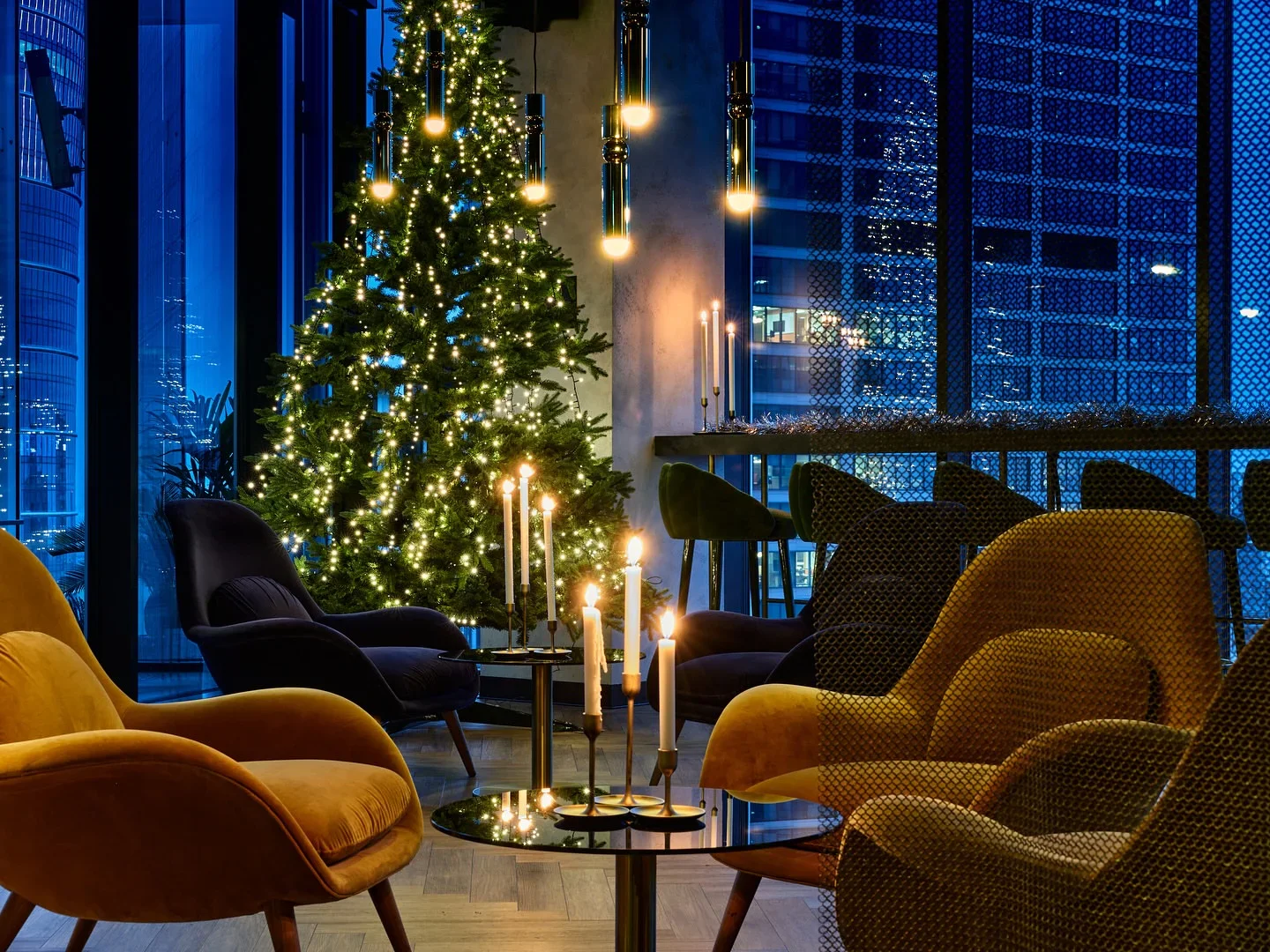 Cozy ambiance at The Rooft Sky Bar in Warsaw featuring Christmas decor, candles, and city views.