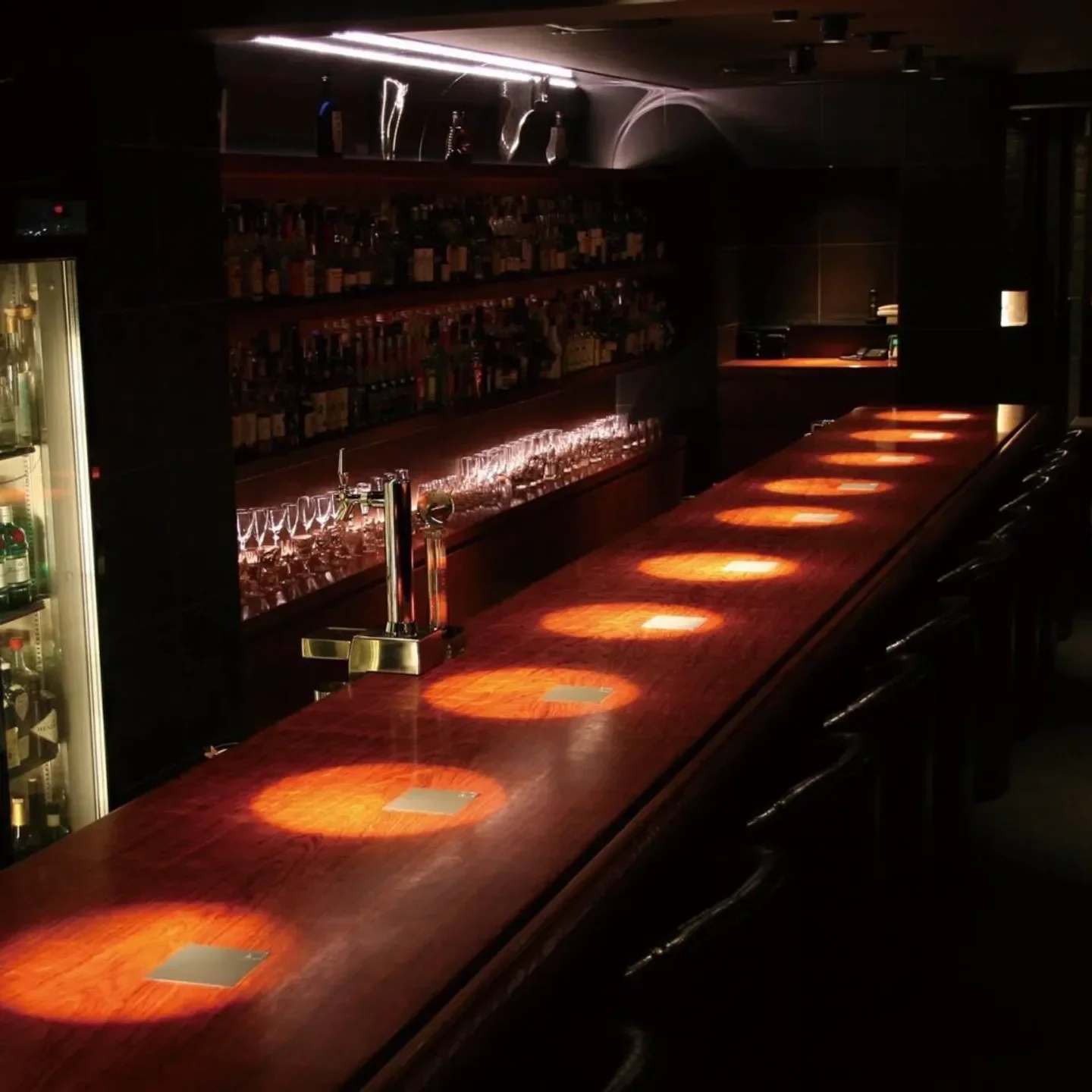 Interior view of The Sailing Bar in Nara, Japan, showcasing a wooden bar.