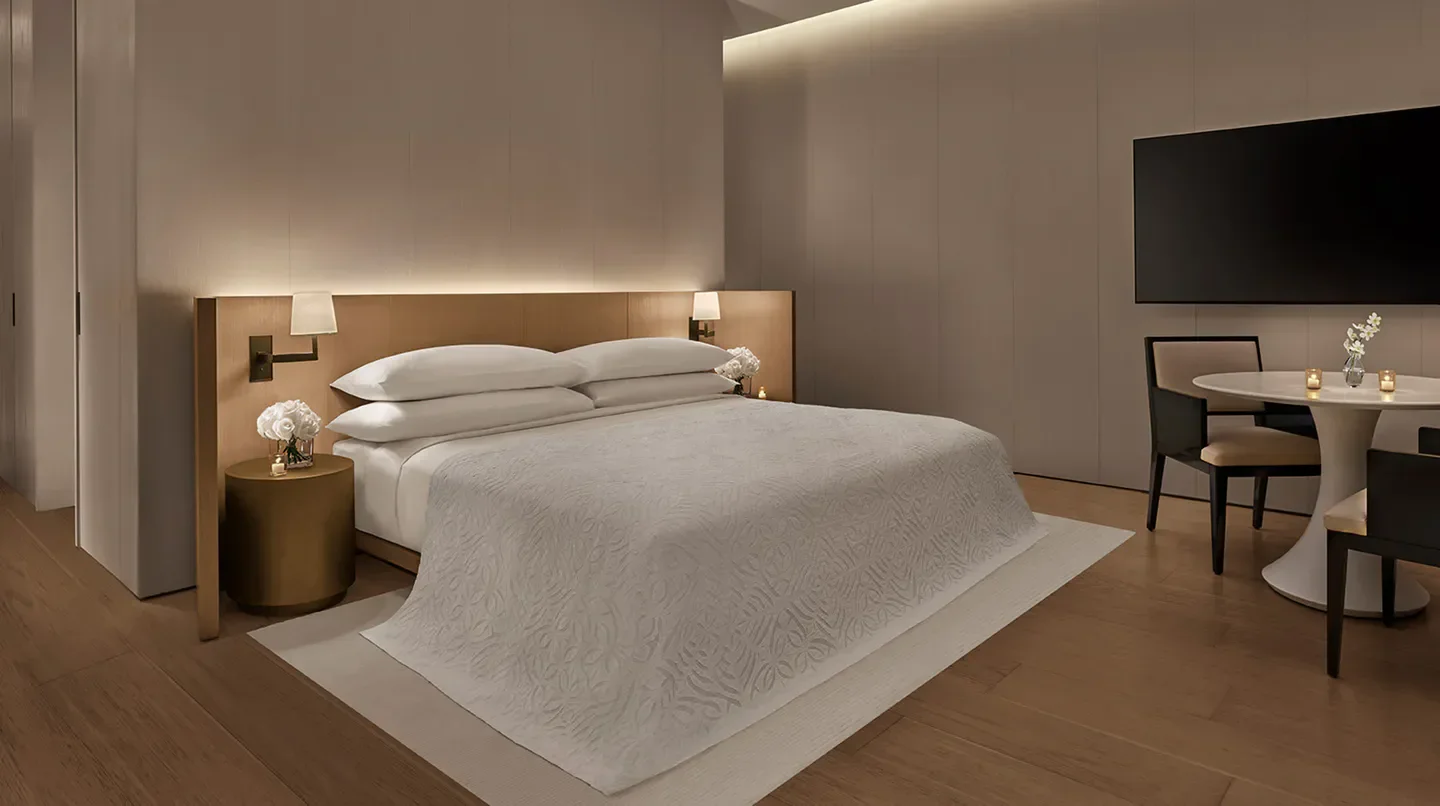 Cozy bedroom interior at The Singapore EDITION hotel in Singapore, featuring elegant design.