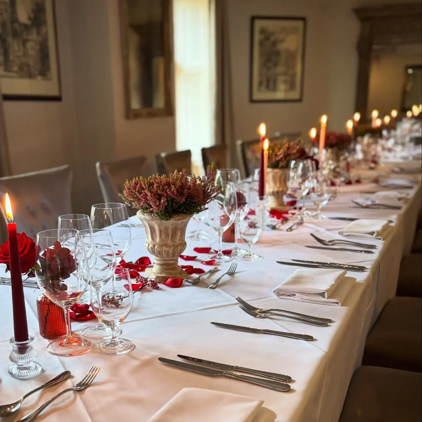 Elegant dining table at The Slaughters Manor House restaurant, Cotswolds, set with candles.