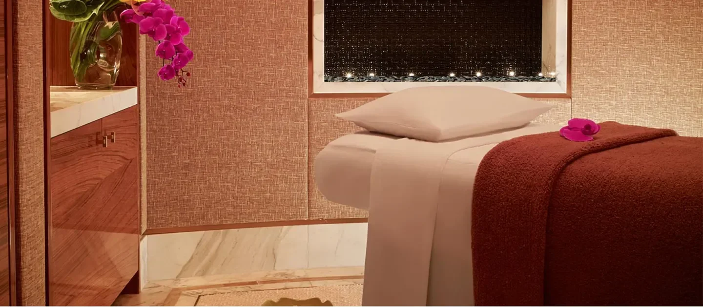 Relaxing spa treatment room at The Spa at Encore Macau, offering a tranquil experience