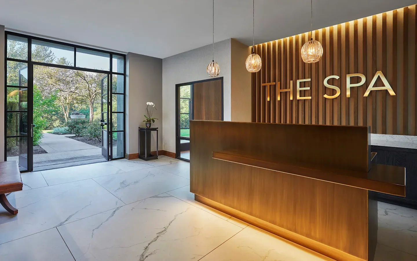 Reception area at The Spa at Four Seasons Hotel Austin, with exterior view of Austin garden.