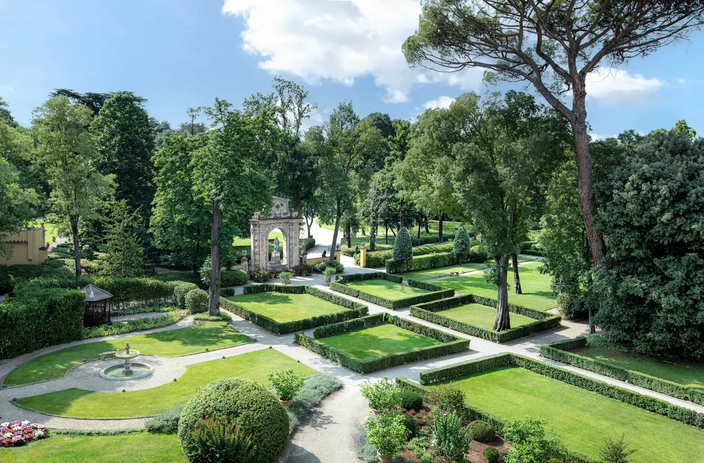 Beautiful garden at The Spa at Four Seasons Hotel Firenze, Florence. Lush greenery and fountains.