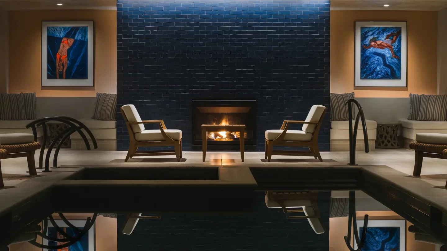 Cozy pool area at The Spa at the Inns of Aurora, New York City, with fireplace and art