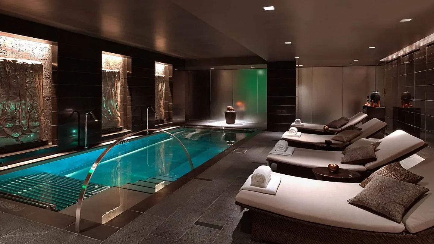 The Spa at The Joule in Dallas, featuring a relaxing pool and lounge chairs.