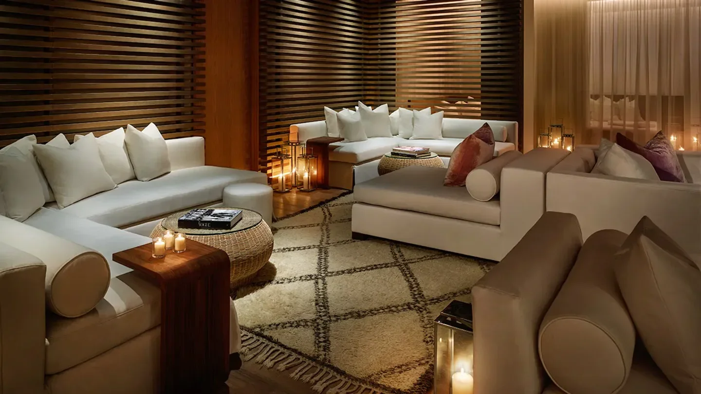 Cozy lounge area at The Spa at The Miami Beach EDITION with soft lighting and seating.