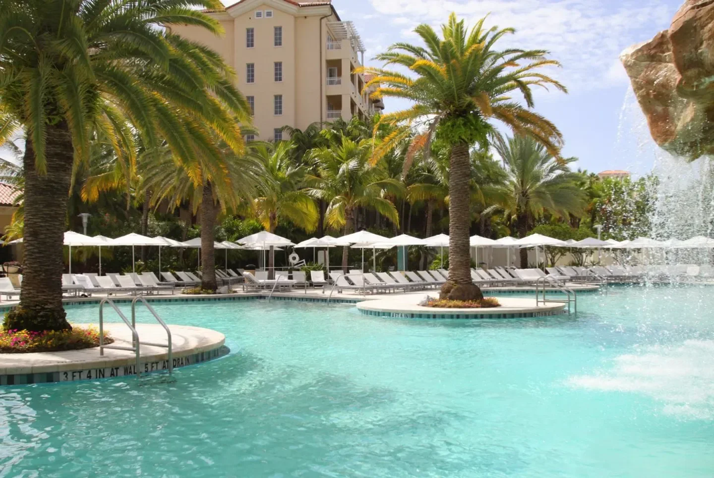 Pool and palm trees at The Spa at Turnberry in The Bahamas