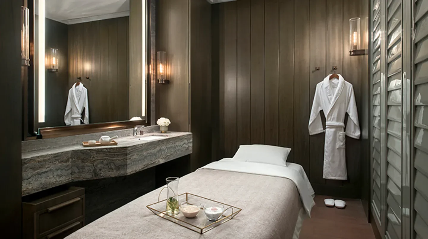 Serene spa treatment room at The St. Regis Athletic Club & Spa in Hong Kong, offering relaxation.