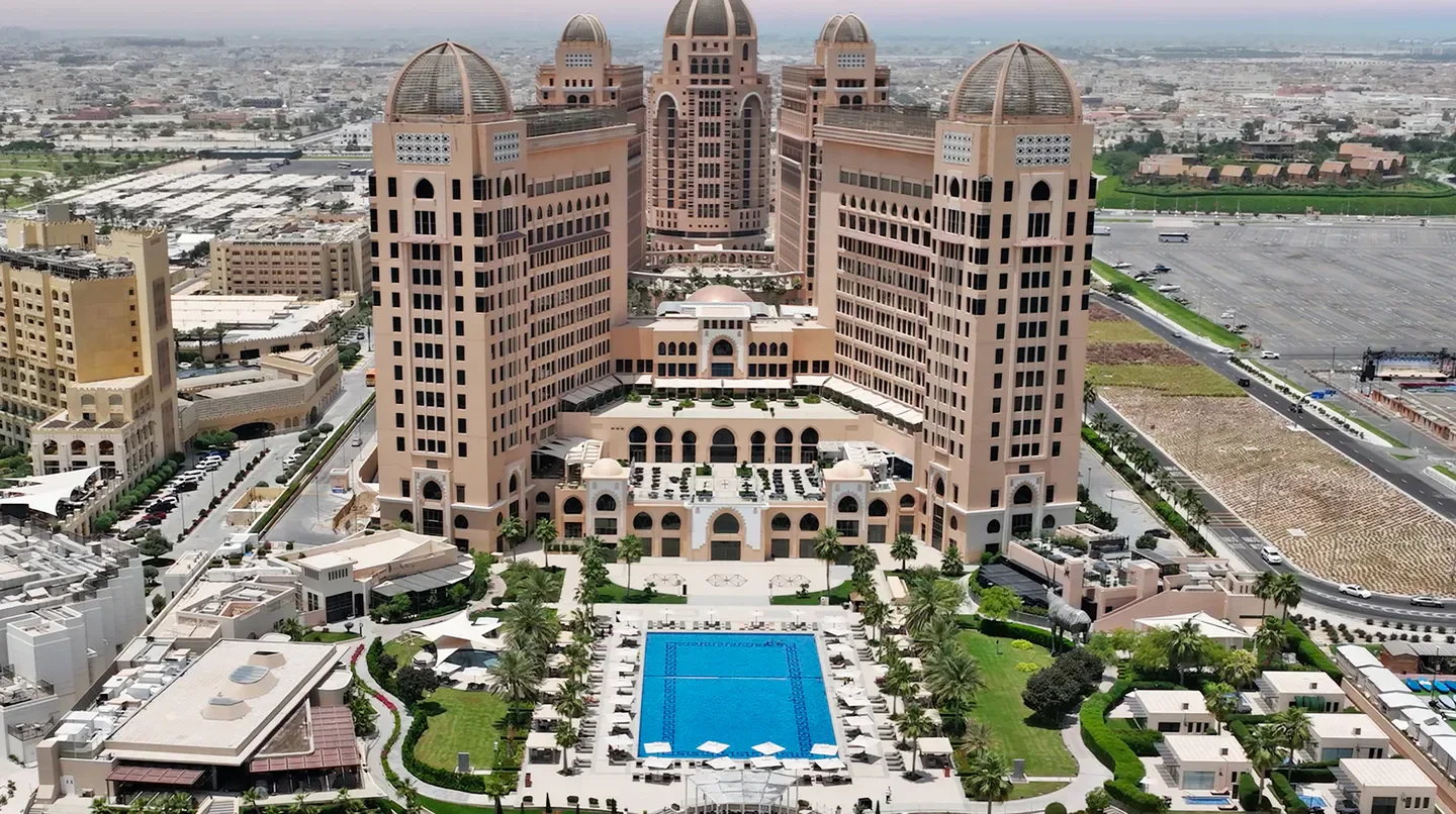 Aerial view of The St. Regis Doha hotel in Doha with stunning architecture and pool.