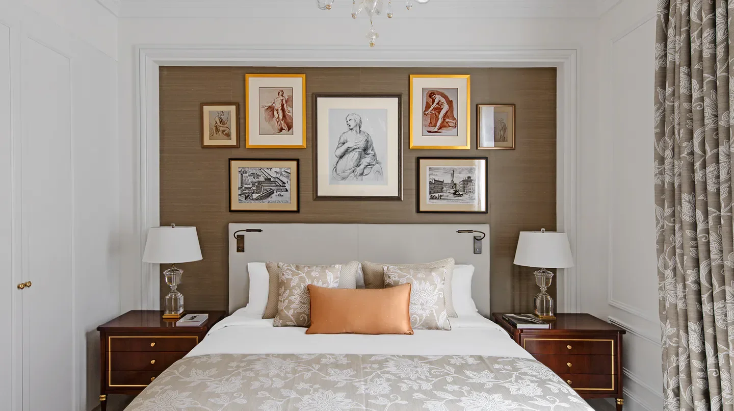 Elegant bedroom at The St. Regis Rome, featuring artwork and a cozy bed in Rome.