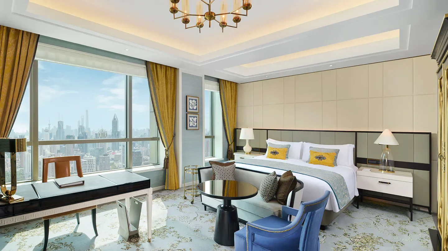 Luxury bedroom at The St. Regis Shanghai Jingan with city views overlooking Shanghai.