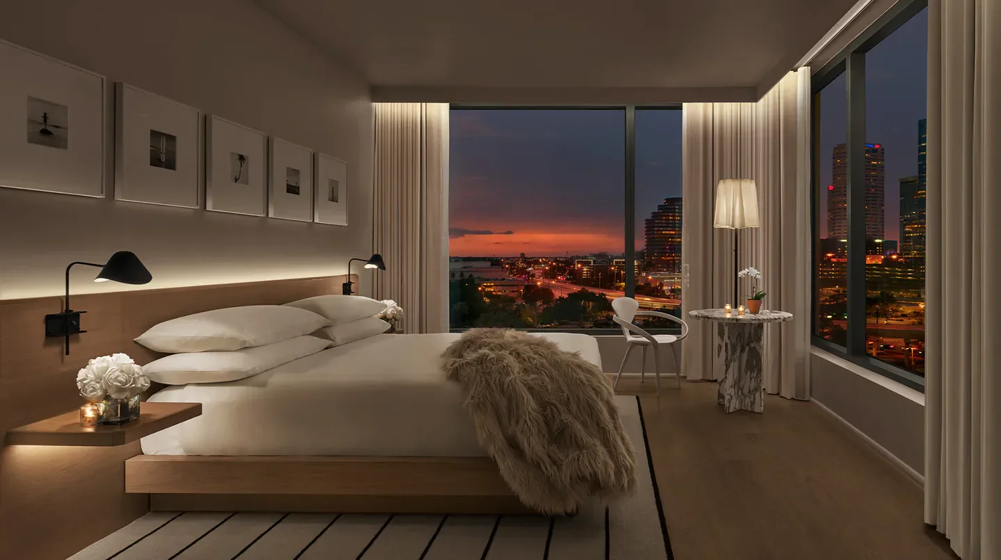 Cozy bedroom at The Tampa EDITION hotel with sunset views over Tampa, Florida.