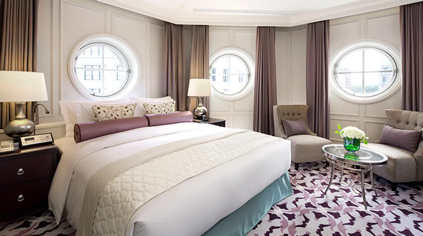 Cozy bedroom at The Tokyo Station Hotel, Tokyo, with elegant decor and round windows