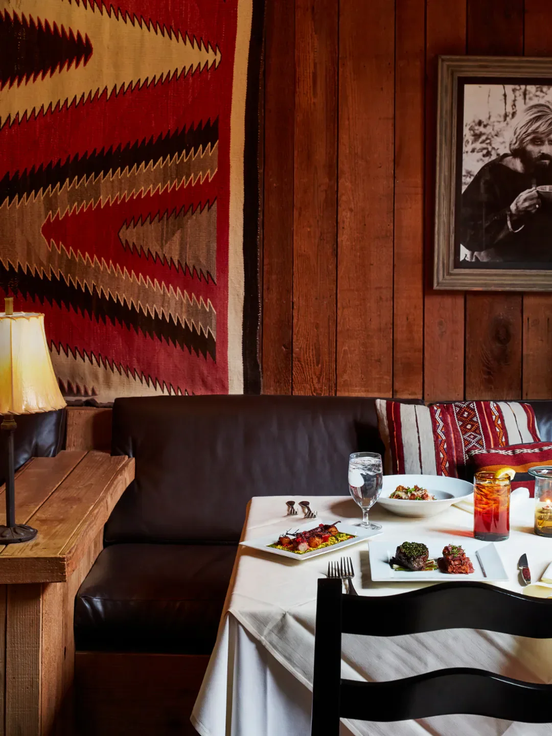 Cozy dining setting at The Tree Room in Park City, with rustic decor and served dishes.