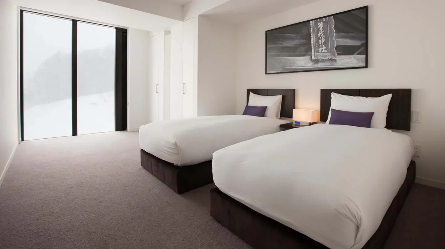 Cozy twin bedroom at The Vale Niseko, Hokkaido, with snowy mountain views